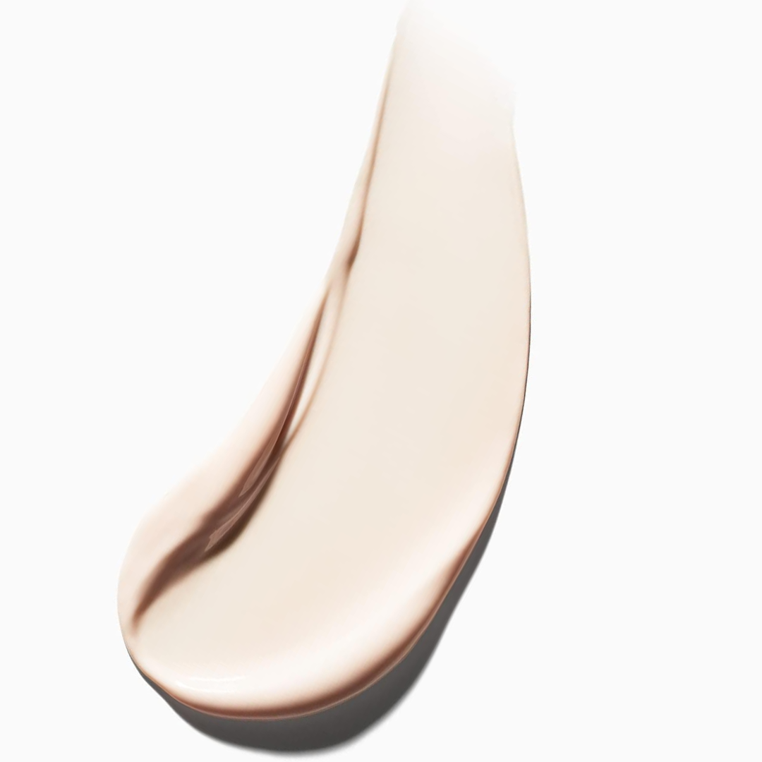 Close-up of a beige cosmetic product smear on a white background