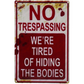 CVNDKN Retro Metal Tin Sign – “No Trespassing, We’re Tired of Hiding The Bodies” – Funny Halloween Wall Décor