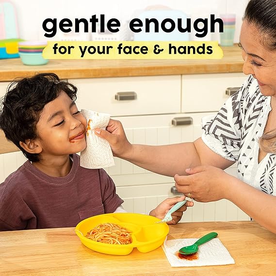 Woman feeding a child spaghetti with a napkin in a kitchen setting, with text 'gentle enough for your face & hands'